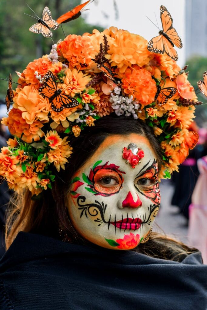 Woman with face paint and floral crown celebrates Day of the Dead.