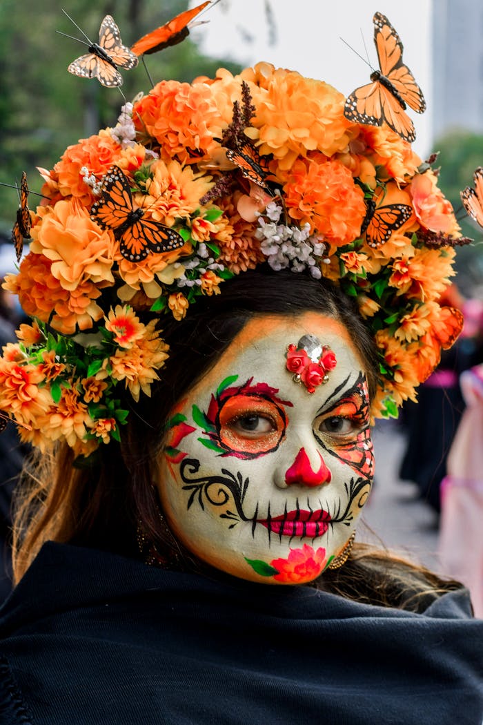 Woman with face paint and floral crown celebrates Day of the Dead.